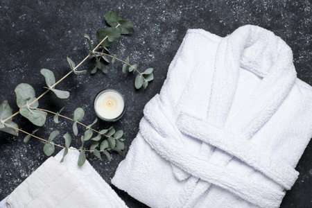 Flat lay composition with bathrobe and spa essentials on black backgroundの写真素材