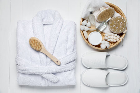 Flat lay composition with bathrobe and spa essentials on white wooden backgroundの写真素材
