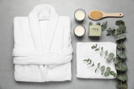 Flat lay composition with bathrobe and spa essentials on light gray backgroundの写真素材