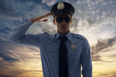 Police force. Man in uniform saluting against sky