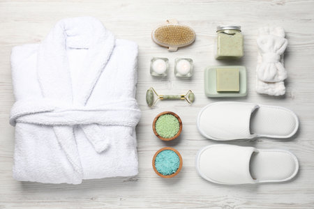 Flat lay composition with bathrobe and spa products on white wooden backgroundの写真素材