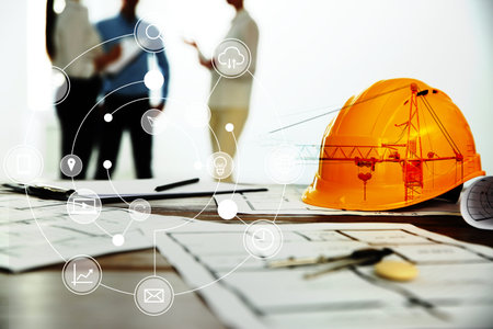 Engineering concept. Colleagues in office, focus on table with construction drawings and tools....