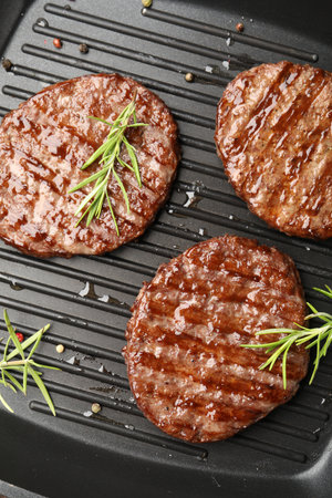 Pan with grilled patties and spices, top viewの写真素材