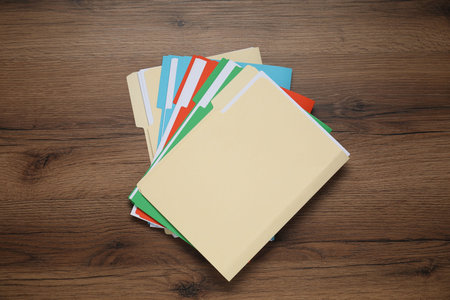 Many documents in folders on wooden table, top viewの写真素材