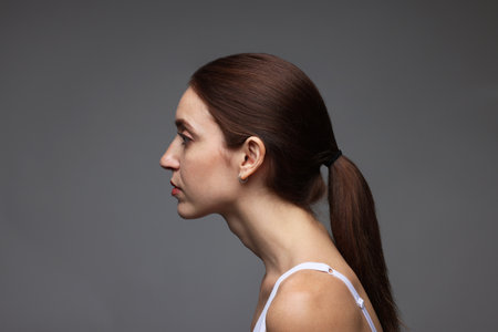 Woman with posture on gray backgroundの写真素材