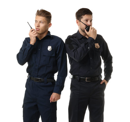 Policemen in uniform with walkie talkies on white background