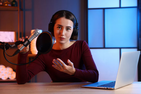 Podcast host recording talk show in studio, view from cameraの写真素材