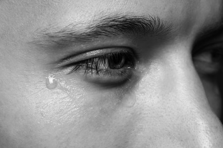 Closeup view of sad man crying. Black and white effectの写真素材