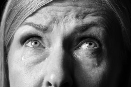 Closeup view of senior woman crying. Black and white effectの写真素材