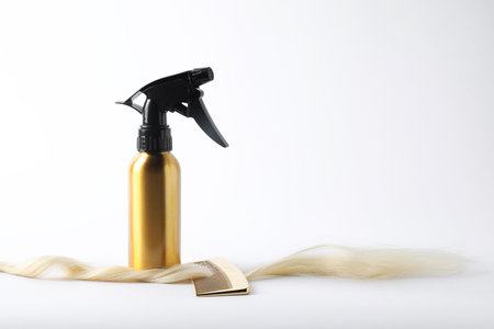 Hair strand, cosmetic product and comb on white background. Space for textの写真素材