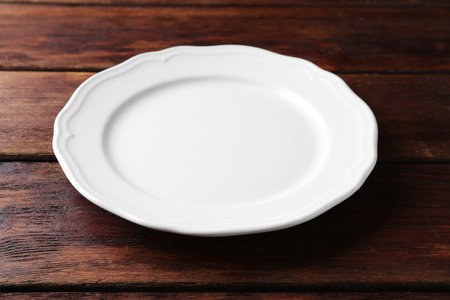 White ceramic plate on wooden table, closeupの写真素材