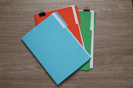 Many documents in folders with binder clips on wooden table, top viewの写真素材
