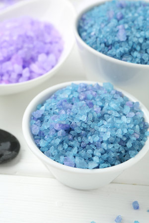 Sea salt in bowls on white wooden table, closeupの写真素材