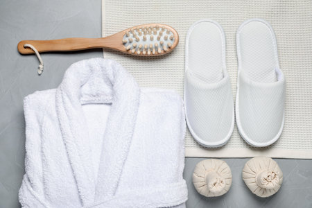 Flat lay composition with bathrobe and spa essentials on light gray backgroundの写真素材