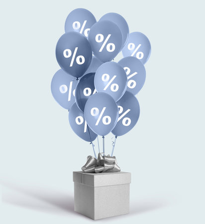 Balloons with percent signs and gift box on light background. Discount offerの写真素材