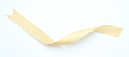 Beautiful yellow ribbon on white background, top view