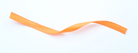 One beautiful orange ribbon on white backgroundの写真素材
