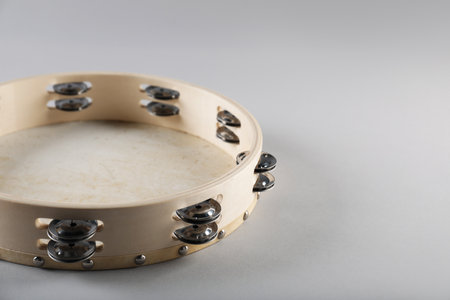 Tambourine on light background, closeup. Space for textの写真素材
