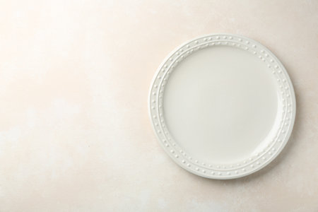 Empty ceramic plate on white table, top view. Space for textの写真素材