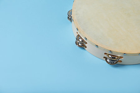 Tambourine on light blue background, closeup. Space for textの写真素材