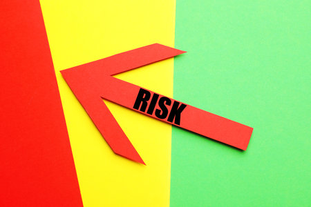 Arrow with word Risk on colorful background, top viewの写真素材