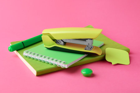 Stapler and other stationery on pink backgroundの写真素材