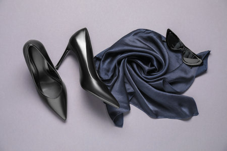 Pair of elegant black heels, sunglasses and scarf on light gray background, flat lay. Stylish shoesの写真素材