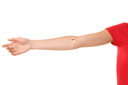Blood donation. Woman with bandage on arm against white background, closeupの写真素材