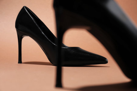 Pair of stylish high heeled shoes on brown background, closeupの写真素材