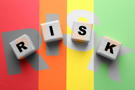 Risk word made of wooden cubes on colorful background, top viewの写真素材