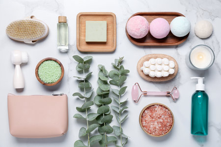 Flat lay composition with spa products and eucalyptus branches on white marble tableの写真素材