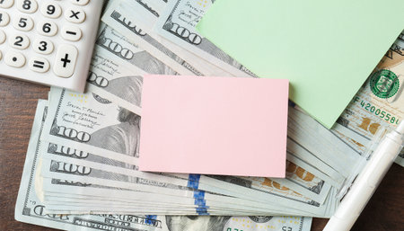 Alimony. Paper notes, money, pen and calculator on wooden table, closeupの写真素材