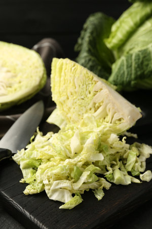 Shredded Savoy cabbage and knife on black table, closeupの写真素材
