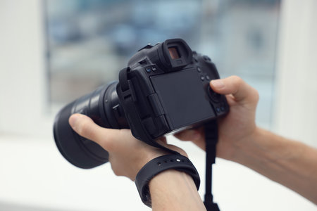 Professional photographer with camera in studio, closeupの写真素材