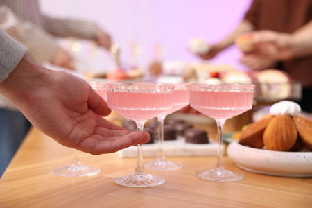 People taking drinks and delicious desserts from buffet table, selective focusの写真素材