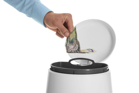 Man throwing money into trash bin on white background, closeupの写真素材