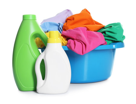 Plastic basin with laundry and detergents isolated on whiteの写真素材