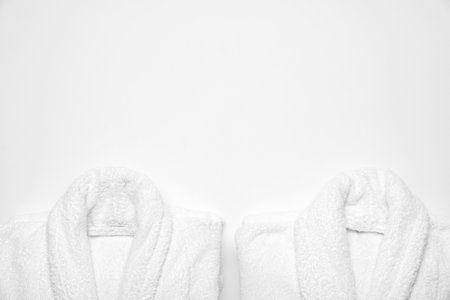 Soft bathrobes on white background, top view with space for text. Spa and relaxの写真素材