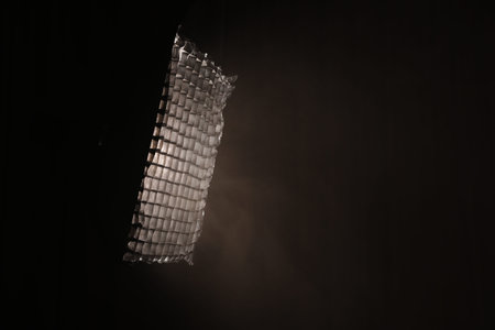 Professional lighting equipment without reflector and smoke on dark background. Space for text