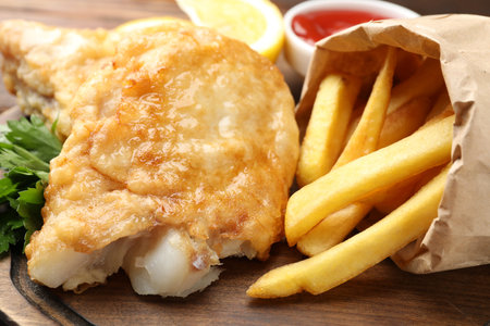 British Traditional Fish and chips on wooden board, closeupの写真素材