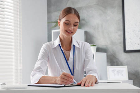 Professional nurse working at table in clinicの写真素材