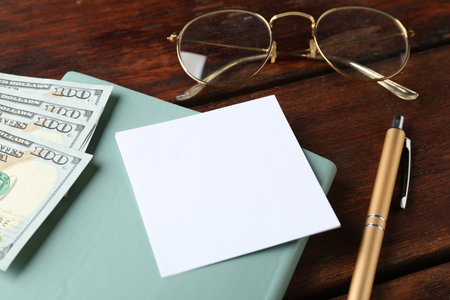 Alimony. Paper note, notebook, pen, money and glasses on wooden table, closeupの写真素材
