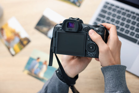 Professional photographer with camera at table, above view