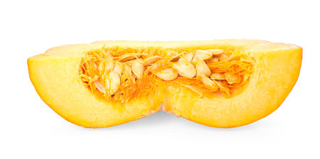 Piece of ripe pumpkin with seeds isolated on whiteの写真素材