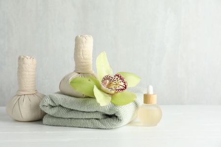 Beautiful spa composition with herbal bags on white wooden table, space for textの写真素材