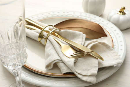 Beautiful table setting with autumn decor on white wooden background, closeup
