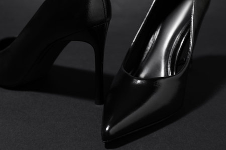 Pair of stylish high heeled shoes on dark background, closeupの写真素材