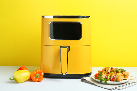 Tasty skewers with chicken, vegetables, parsley on white tableの写真素材