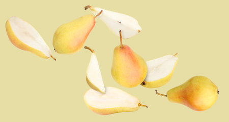 Many fresh pears falling on dark beige backgroundの写真素材
