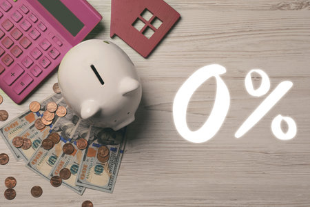 Zero commission. Piggy bank, model of house, money and calculator on table, top view. 0 percent signの写真素材